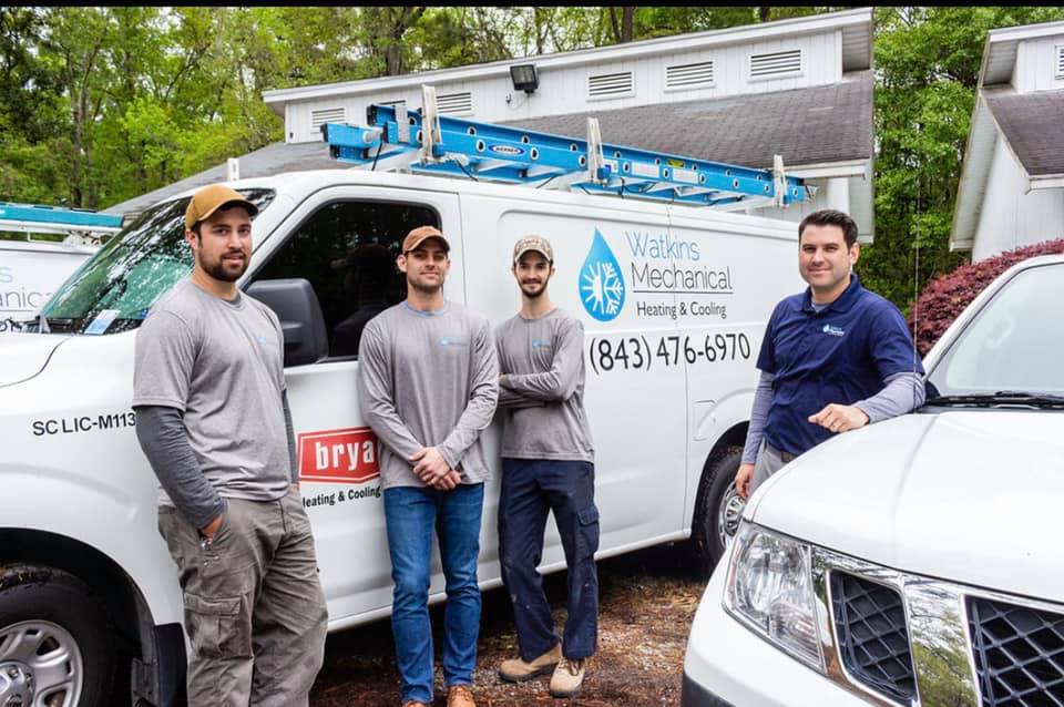 Watkins Mechanical team (4 men) in front of a work van