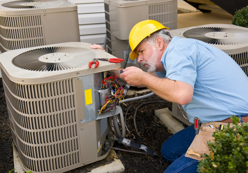Repairman working on HVAC unit