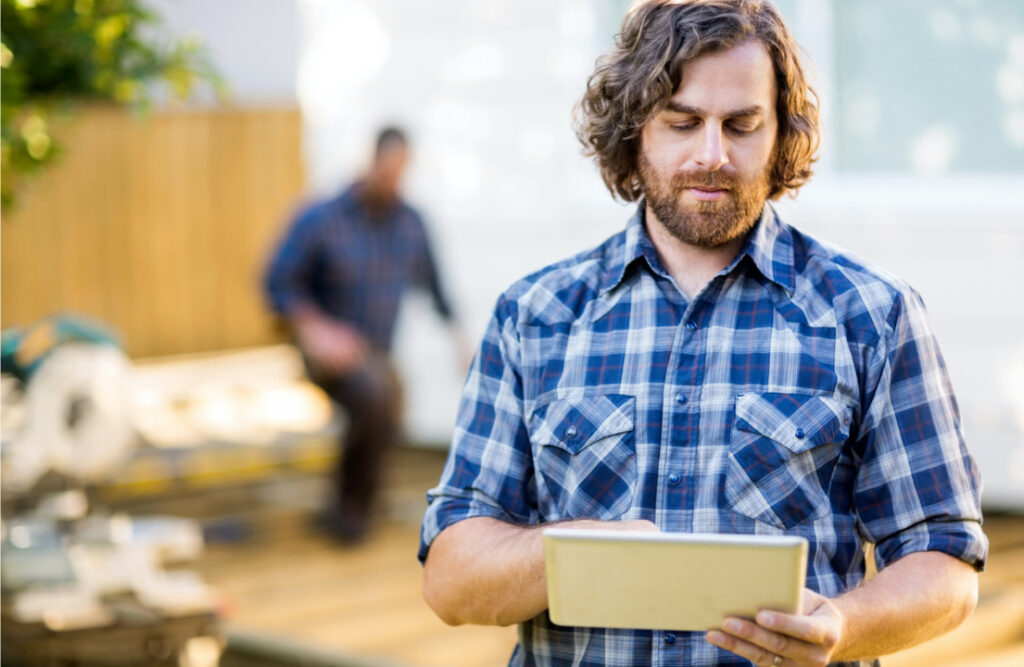 Man in plaid shirt on a tablet
